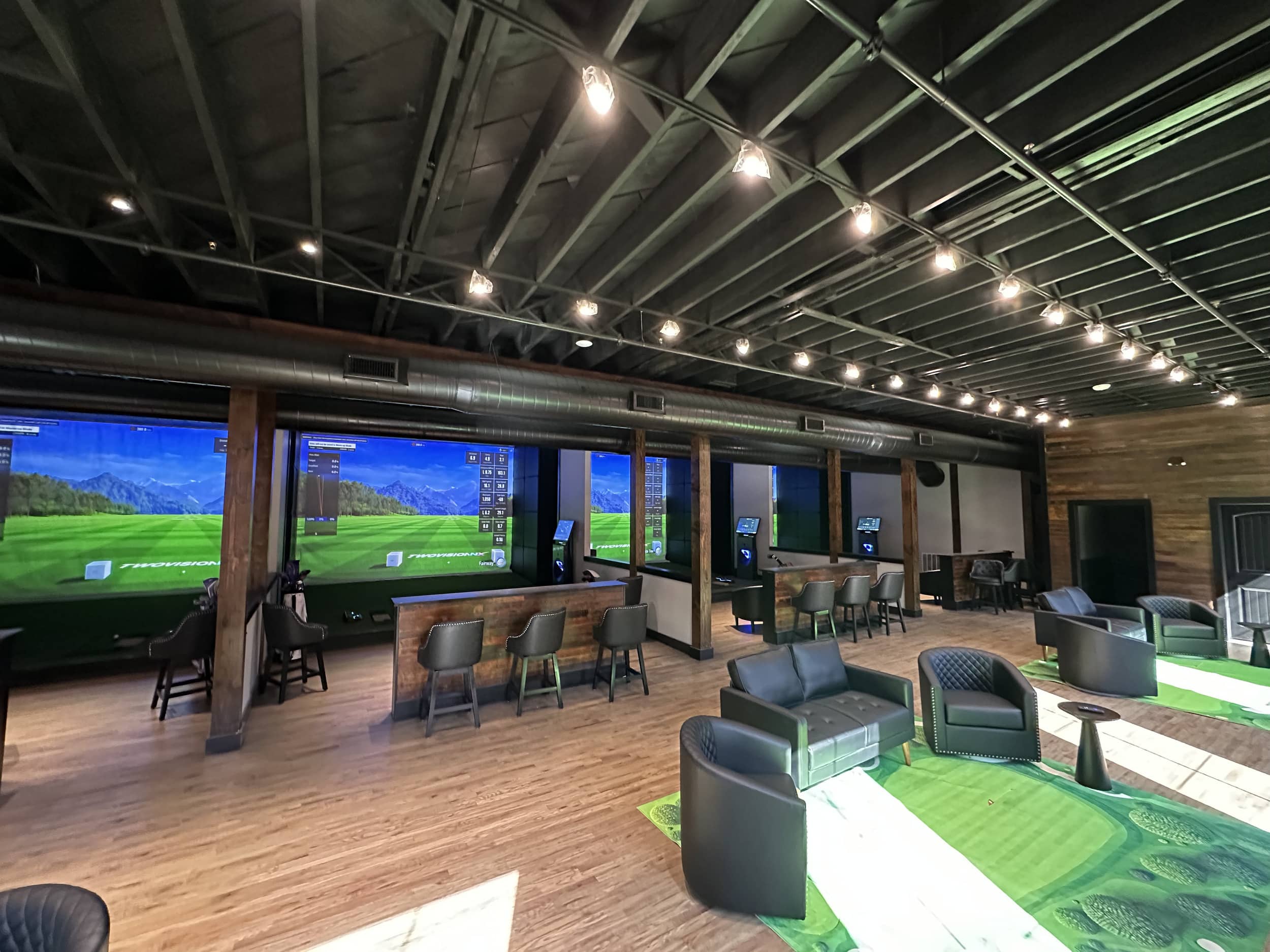 golf simulator bays with seating areas